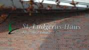 Glockensymbol und Schriftzug St. Ludgerus-Haus an der Hauswand